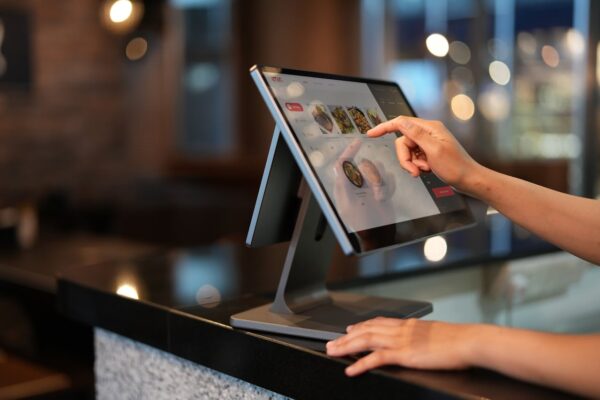 A Close-Up Shot of a Cashier Using a Point of Sale System